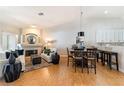 Bright living room with fireplace open to the dining area and kitchen at 7648 Rolling View Dr # 201, Las Vegas, NV 89149