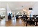 Open floor plan with bright living and dining area featuring hardwood floors and fireplace at 7648 Rolling View Dr # 201, Las Vegas, NV 89149