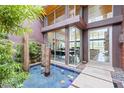Private courtyard with water feature, lush plants, and views into the house at 8 Meadowhawk Ln, Las Vegas, NV 89135