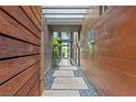 Unique entry with stone pavers, modern lighting, and sleek wood paneling at 8 Meadowhawk Ln, Las Vegas, NV 89135