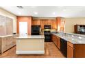 This spacious kitchen features a granite island, stainless appliances and wood cabinets at 8316 Mokena Ave, Las Vegas, NV 89178