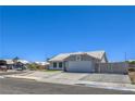 Single-story house with desert landscaping, driveway, and a two-car garage at 842 Envoy Cir, Henderson, NV 89002
