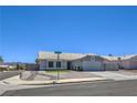 Well-kept single-story home featuring a low-maintenance front yard and a two-car garage at 842 Envoy Cir, Henderson, NV 89002