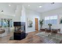 Bright living room with wood floors, modern fireplace and dining area at 8981 Rivers Edge Dr, Las Vegas, NV 89117