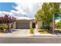 Attractive single-story home featuring desert landscaping, a two-car garage, and a tiled roof at 913 Hickory Park St, Las Vegas, NV 89138