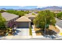 Beautiful single-story home with desert landscaping, a two-car garage, and a tile roof at 913 Hickory Park St, Las Vegas, NV 89138