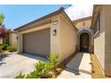 Close-up of a home's front entry, highlighting its desert-style landscaping and gray garage door at 913 Hickory Park St, Las Vegas, NV 89138