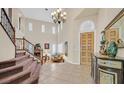 Elegant foyer with a grand staircase, high ceilings, and stylish decor at 10001 Blairwood Ct, Las Vegas, NV 89178