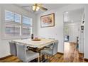 The dining room has wood floors, a ceiling fan, and a large window at 1008 Welkin St, Henderson, NV 89052