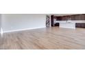 Expansive living room with wood floors leading into an open concept kitchen at 10184 Juniper Valley St, Las Vegas, NV 89166