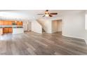 Open-concept living space with stairs leading to the second floor adjacent to the kitchen at 10717 Red Badge Ave, Las Vegas, NV 89166