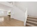 Bright foyer featuring a staircase and light hardwood floors at 1075 Page Park Ln, Henderson, NV 89011