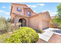 Inviting two-story home with a well-manicured front yard, arched entry, and a two-car garage at 11749 Villa San Michele Ct, Las Vegas, NV 89138