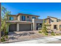Contemporary home featuring a three-car garage, desert landscaping, and a neutral color palette at 12332 Switchgrass Ave, Las Vegas, NV 89138