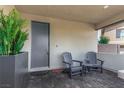 Cozy covered front porch with outdoor seating and a decorative planter providing curb appeal at 12332 Switchgrass Ave, Las Vegas, NV 89138