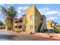Multi-story building featuring private balconies, complemented by well-kept landscaping and nearby parking at 1812 N Decatur Blvd # 103, Las Vegas, NV 89108