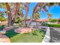 Inviting single story home with desert landscaping, large trees and a brick paved driveway at 2101 Plaza Del Fuentes, Las Vegas, NV 89102
