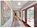 Well-lit hallway with beautiful artwork, wood floors and decorative rugs at 2101 Plaza Del Fuentes, Las Vegas, NV 89102