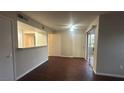 Open-concept living space boasts dark flooring and sliding doors to a balcony at 2300 E Silverado Ranch Blvd # 1104, Las Vegas, NV 89183