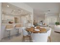 This light and bright kitchen offers an open design with counter seating and white cabinetry at 2808 Crown Ridge Dr, Las Vegas, NV 89134