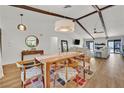 Open floor plan with dining area, living area with comfortable seating, and wood beam ceiling at 3220 Calle De El Cortez, Las Vegas, NV 89102