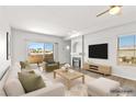 Bright living room featuring a cozy fireplace, plush seating, and a sliding glass door to the balcony at 3608 Quetonia St # 204, Las Vegas, NV 89108