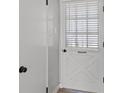White front door with glass detailing leading to the interior of the home at 4204 El Jardin Ave, Las Vegas, NV 89102