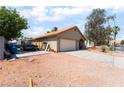 A single-story house with desert landscaping and a two-car garage at 4335 Twin Peaks Dr, North Las Vegas, NV 89032
