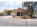Charming single-story house with desert landscaping, an arched entryway, and a two-car garage at 4335 Twin Peaks Dr, North Las Vegas, NV 89032