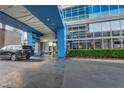 Stylish building entrance with glass doors and blue accents; car parked outside at 4525 Dean Martin Dr # 2903, Las Vegas, NV 89103
