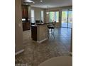Open concept kitchen with a breakfast bar and access to the outdoor patio at 5110 Silenzio St, Las Vegas, NV 89135
