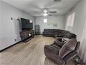 A beautifully staged living room featuring a large sectional, tile floors, and ample natural light at 5419 Brass Hills Ct, Las Vegas, NV 89122