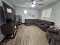 A beautifully staged living room featuring a large sectional, tile floors, and ample natural light at 5419 Brass Hills Ct, Las Vegas, NV 89122