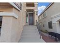 Inviting front entrance features a long stairway, modern hardware, and well-maintained exteriors at 6056 Atlantis Dream Ave, Las Vegas, NV 89139
