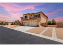 View of a two story home featuring a tile roof and three car garage, desert landscaping, and fenced yard at 6351 Abacus Farms Ct, Las Vegas, NV 89131