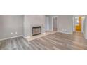 Living room boasts wood-look floors and a cozy fireplace with tile surround at 701 Capri Dr # 6A, Boulder City, NV 89005