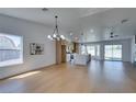 Open-concept living room with modern kitchen, hardwood floors, recessed lighting, and bright airy feel at 7133 Tropical Island Cir, Las Vegas, NV 89129