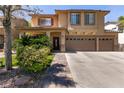 Well-maintained two-story home with a three-car garage, desert landscaping, and a cozy porch at 815 Adagio St, Henderson, NV 89052