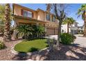 Charming front yard with manicured turf, palm trees, and a well-maintained exterior at 815 Adagio St, Henderson, NV 89052