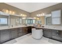 Spacious primary bath offers dual sinks, vanity seating, and ample storage with a large mirror at 8531 W Oquendo Rd, Las Vegas, NV 89113