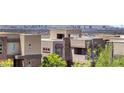 Upscale neighborhood featuring modern home designs and city views in the distance at 865 Auroras Edge Ct, Henderson, NV 89012