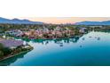 Panoramic aerial view showcasing the waterfront homes and community, highlighting the serene lake and mountain backdrop at 8725 Newport Isle Ct, Las Vegas, NV 89117