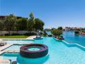 Resort-style pool and jacuzzi with a water slide, perfect for relaxation and entertainment on a sunny day at 8725 Newport Isle Ct, Las Vegas, NV 89117