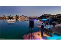 Lakeside view of the community, complete with docks and boats, reflecting the vibrant waterfront lifestyle at 8725 Newport Isle Ct, Las Vegas, NV 89117