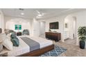 Bright main bedroom with ceiling fan, sitting area, en-suite bathroom and walk-in closet at 9006 Cedar Door Ave, Las Vegas, NV 89148