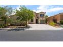 Two-story home with a desert landscape, one car garage, and a large driveway at 9319 White Waterfall Ave, Las Vegas, NV 89149