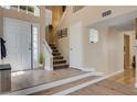 Bright foyer features beautiful flooring, staircase, and natural light at 9333 Dry Dock Dr, Las Vegas, NV 89117