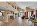 Open-concept living area flows to outdoor pool with brick fireplace and abundant natural light at 9333 Dry Dock Dr, Las Vegas, NV 89117