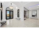 Elegant entryway with a crystal chandelier, large windows, and access to a glass-encased wine room at 9605 Verlaine Ct, Las Vegas, NV 89145