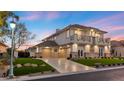 Spacious home with a three-car garage, well-manicured lawn and landscape, and a paved driveway at 9605 Verlaine Ct, Las Vegas, NV 89145